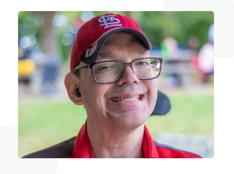 Man wearing a St. Louis Cardinal's Baseball cap and eyeglasses